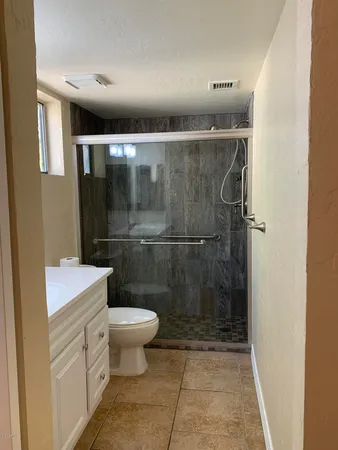 a bathroom with a toilet and a shower