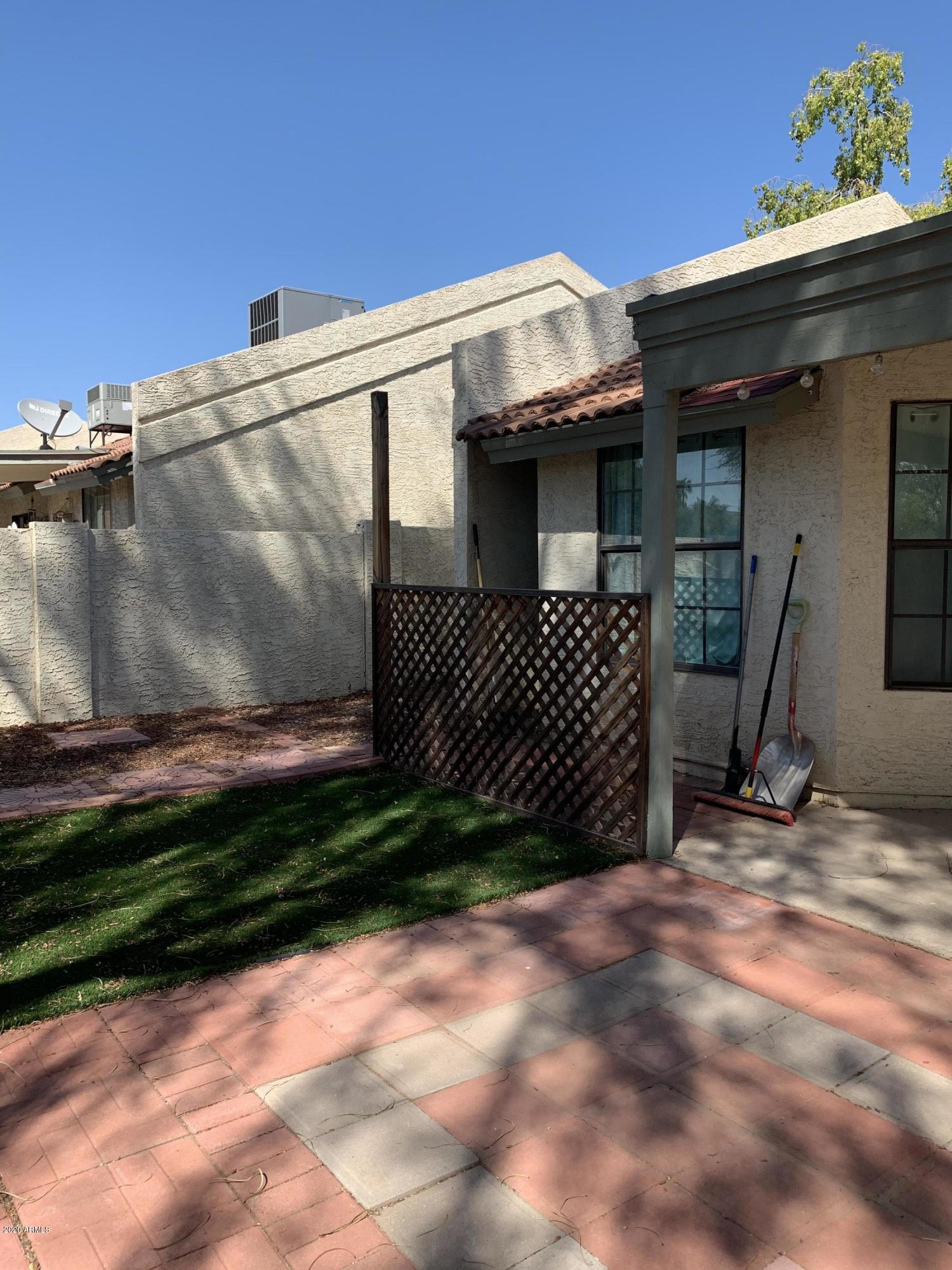 1500 North Sunview Parkway, Unit 20 Gilbert, AZ 85234 - Photo 10 of 12 a view of a house with a wooden fence