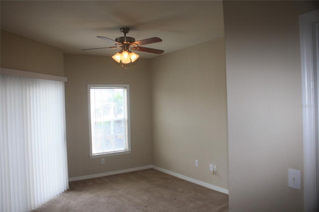 3621 Conroy Road, Unit 739 Orlando, FL 32839 - Photo 16 of 20 an empty room with a window and a fan