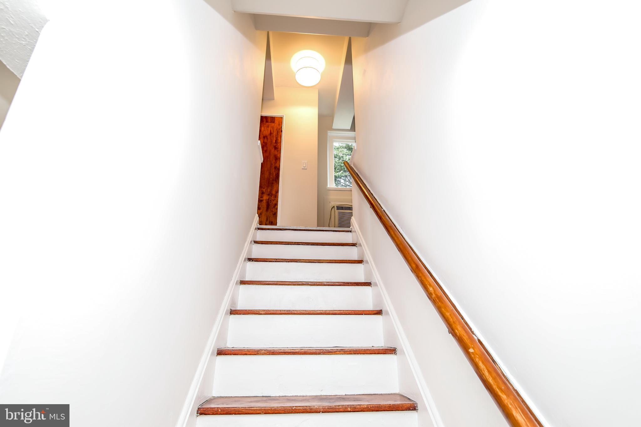 10 Hillside Road, Unit A Greenbelt, MD 20770 - Photo 29 of 44 Hardwood stairs with freshly painted risers