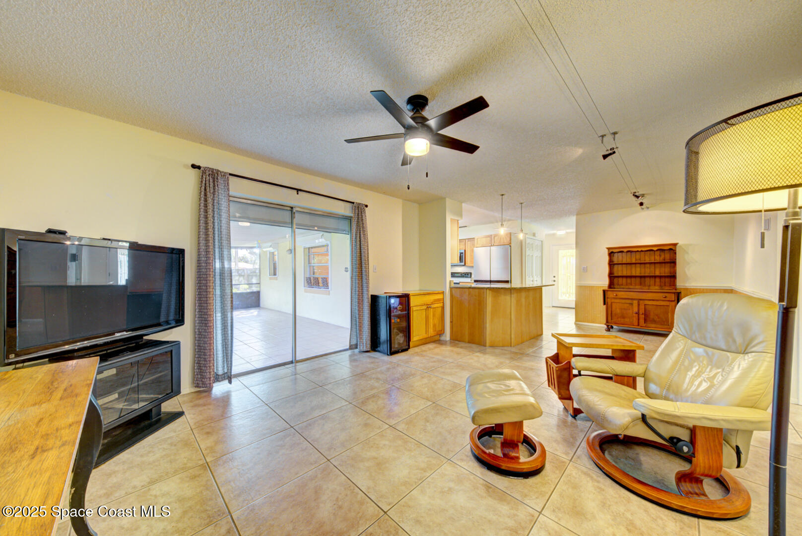4610 Dunsford Road Titusville, FL 32796 - Photo 6 of 28 family room with fan