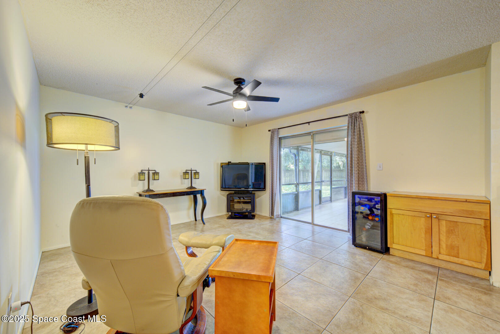4610 Dunsford Road Titusville, FL 32796 - Photo 7 of 28 family room with slider to porch
