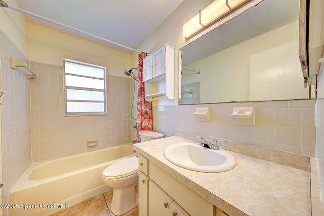 a view of a dining room with furniture and a chandelier