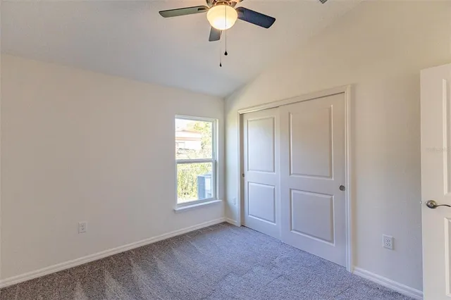 an empty room with windows and cabinet