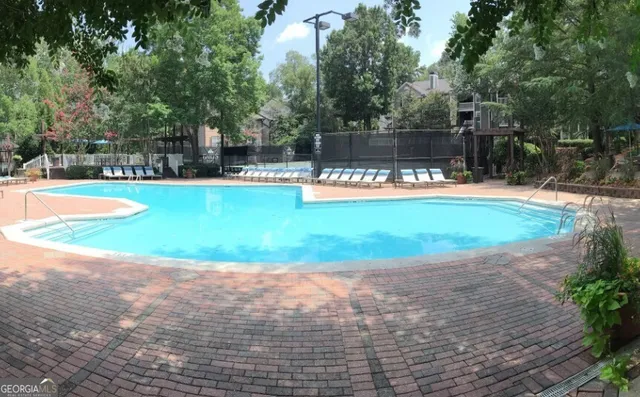 a view of a swimming pool with a patio