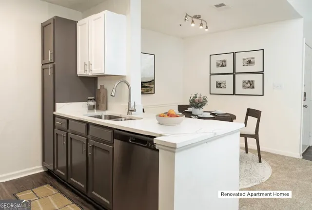 a kitchen with a sink cabinets and a refrigerator