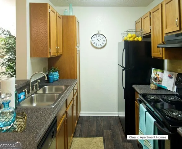 a kitchen with a sink and a refrigerator