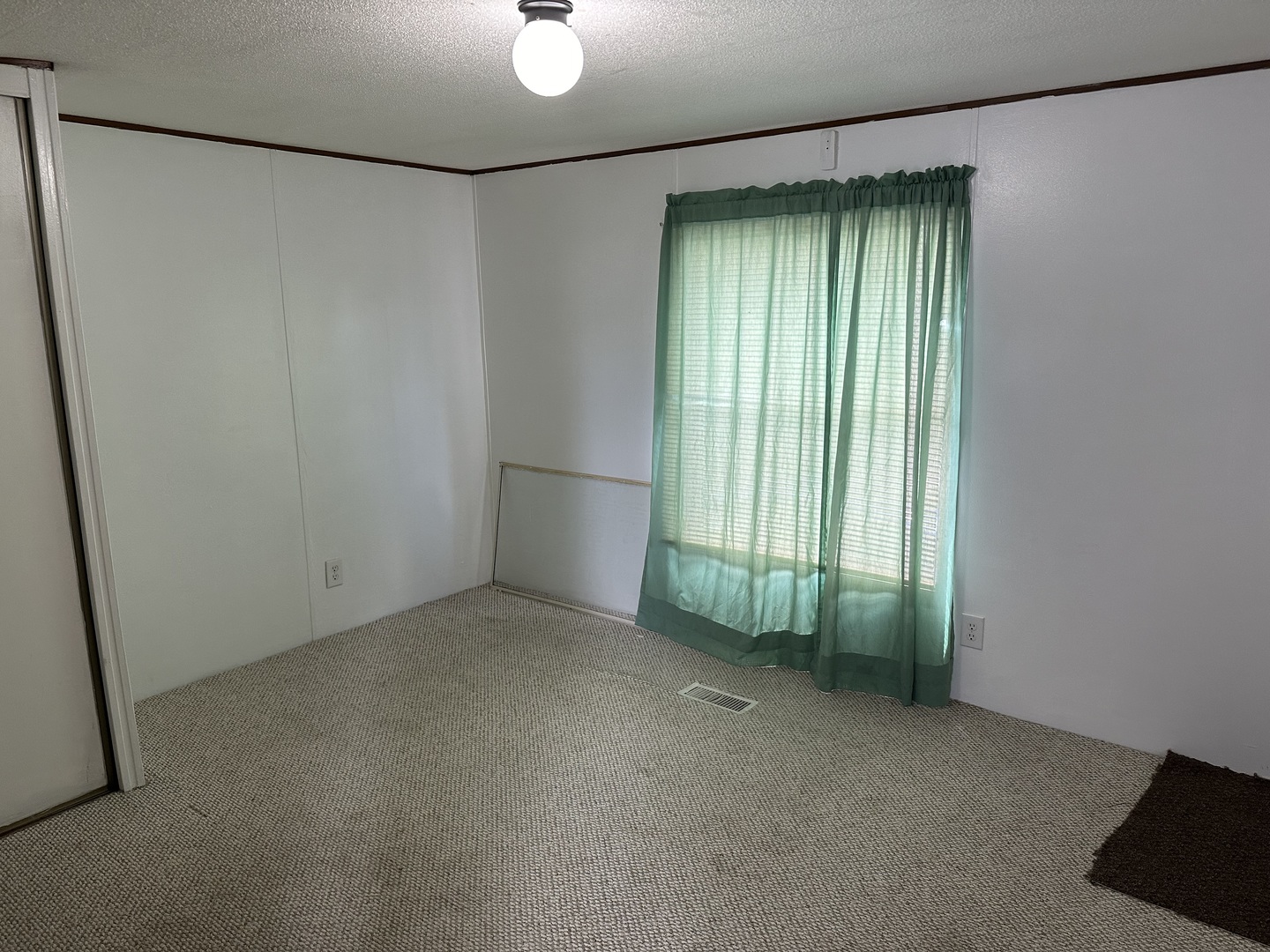 10557 North State Rte 50, Unit 11 Manteno, IL 60950 - Photo 3 of 11 a view of an empty room with a window