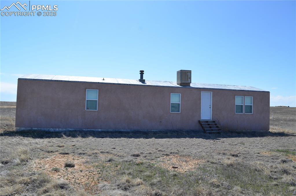 Front view of house featuring entry steps and central AC unit