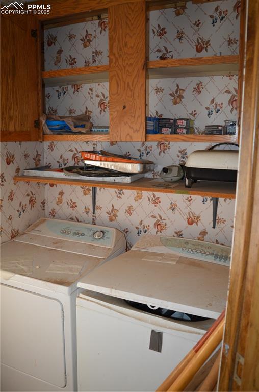 1604 County Road R Rush, CO 80833 - Photo 16 of 16 Clothes washing area with wallpapered walls and washing machine and clothes dryer