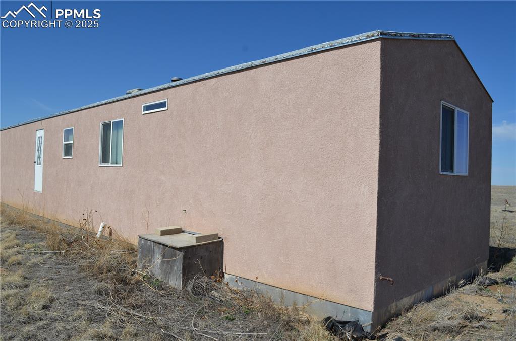 1604 County Road R Rush, CO 80833 - Photo 3 of 16 View of home's exterior featuring stucco siding