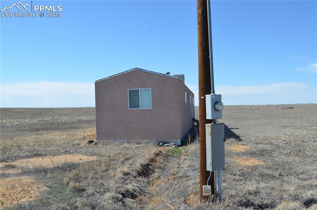 1604 County Road R Rush, CO 80833 - Photo 4 of 16 Details featuring stucco siding and electric meter