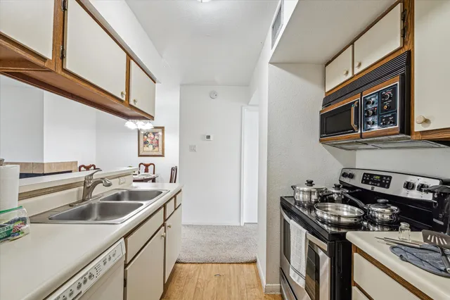 a kitchen that has a sink and a stove