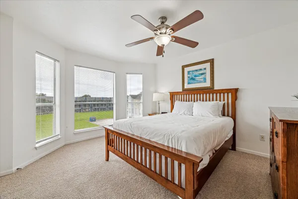 a bedroom with a large bed and a large window