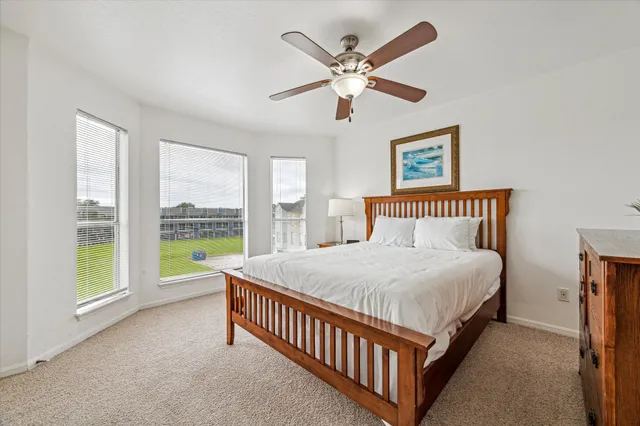 a bedroom with a large bed and a large window