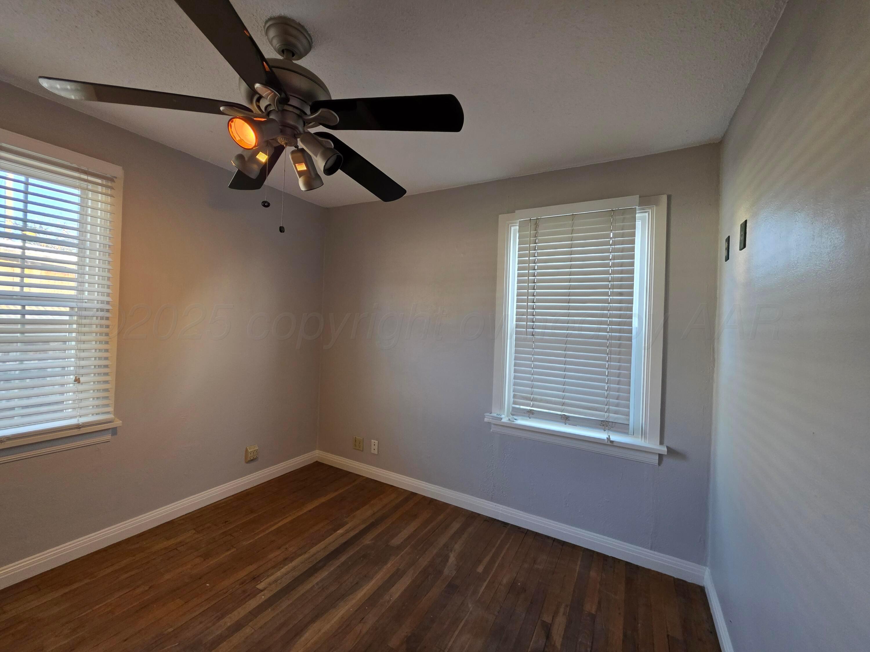3609 South Jackson Street Amarillo, TX 79110 - Photo 20 of 30 a view of an empty room with wooden floor and a window