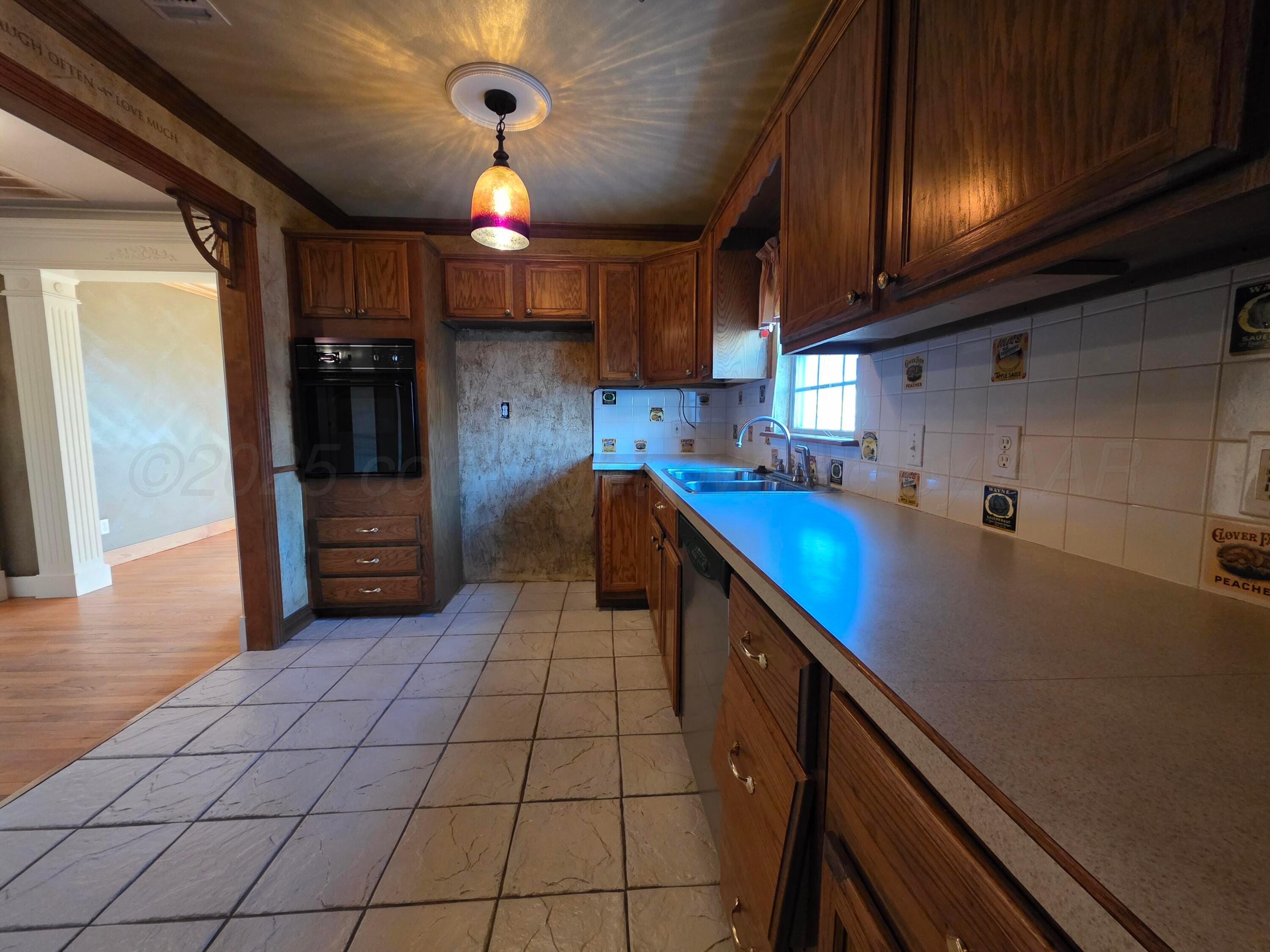 3609 South Jackson Street Amarillo, TX 79110 - Photo 8 of 30 a kitchen with stainless steel appliances granite countertop a sink and cabinets