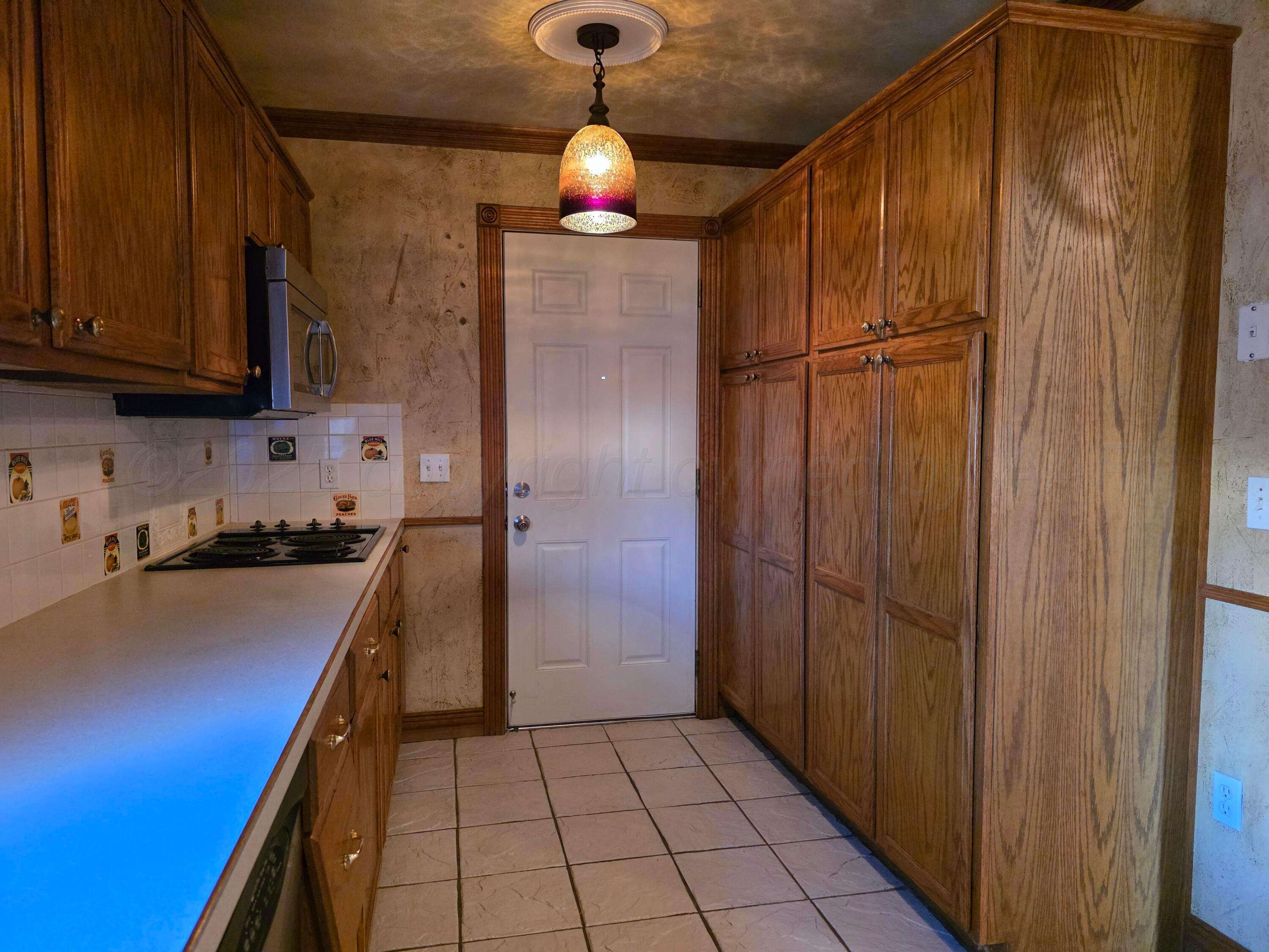 3609 South Jackson Street Amarillo, TX 79110 - Photo 10 of 30 a kitchen with stainless steel appliances granite countertop a refrigerator and a sink