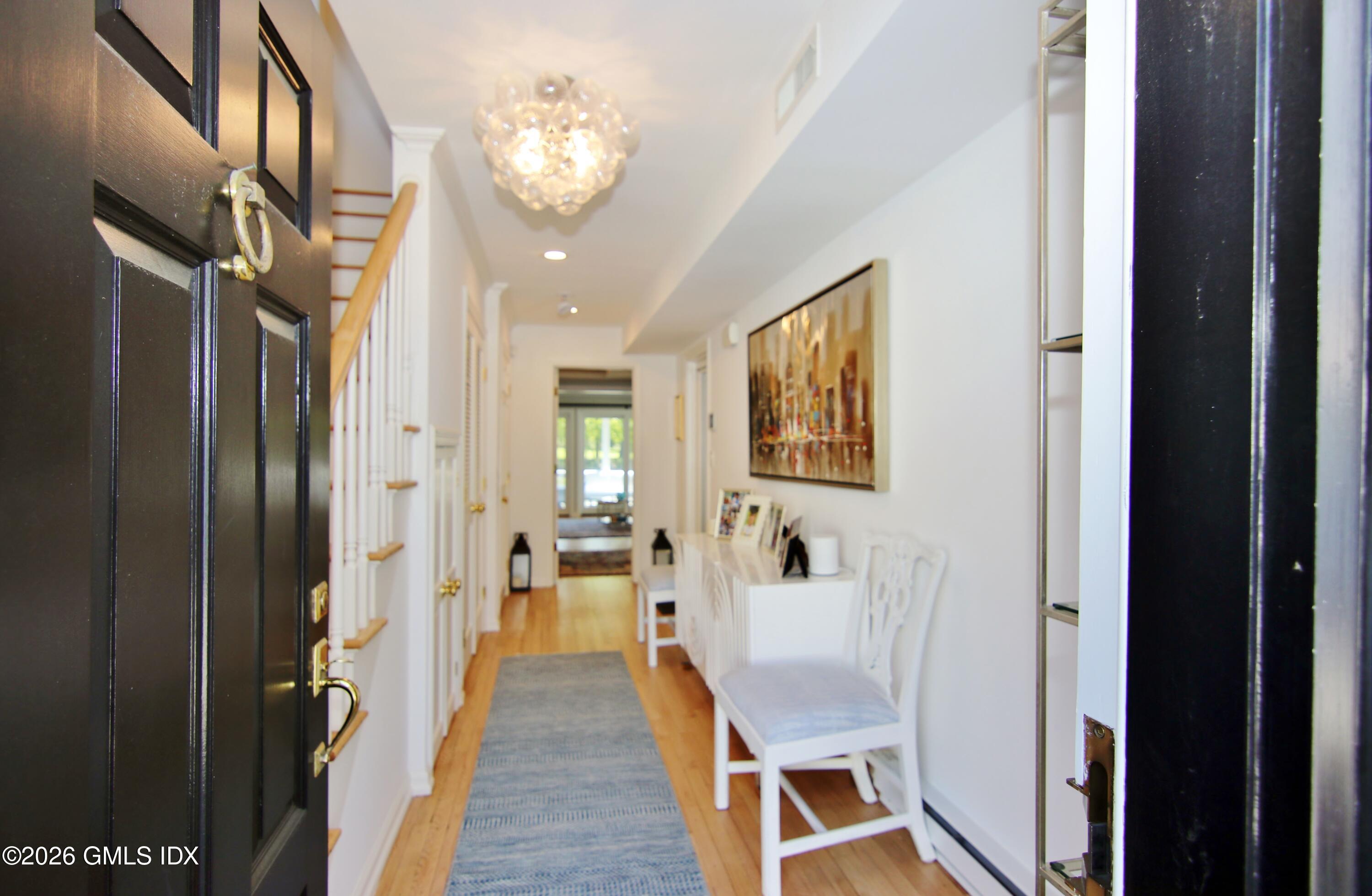 633 Steamboat Road, Unit 5 Greenwich, CT 06830 - Photo 25 of 29 a view of a hallway with wooden floor and staircase