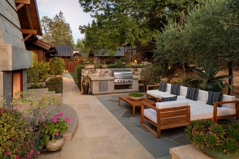a view of a backyard with sitting area