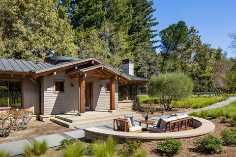 a view of house with backyard outdoor seating and green space