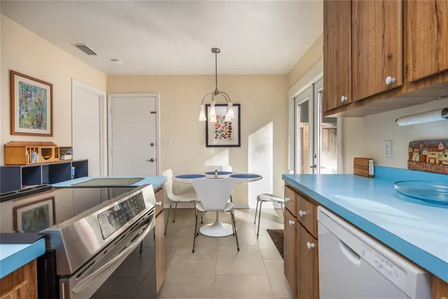 a kitchen that has a lot of cabinets refrigerator oven and a sink