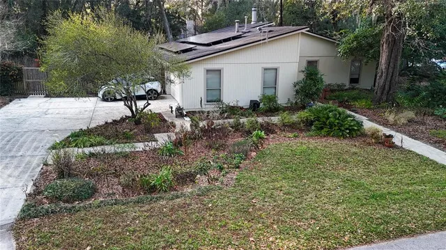 a view of a house with a yard and plants