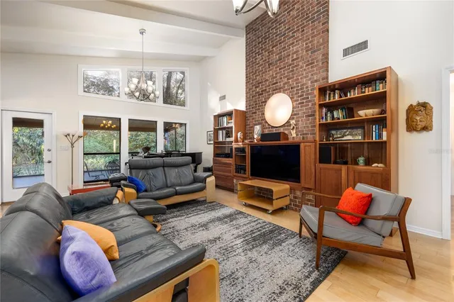 a living room with furniture a rug and a chandelier