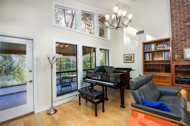 a living room with furniture and a floor to ceiling window