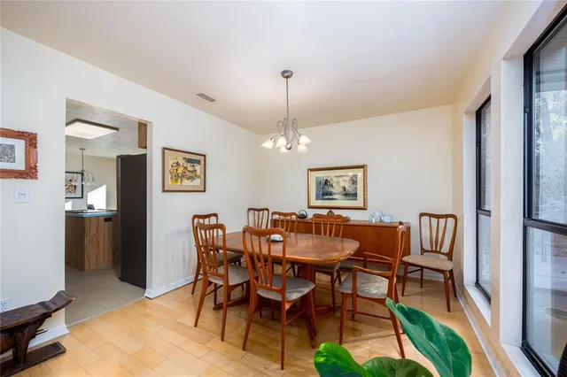 a view of a dining room with furniture and chandelier