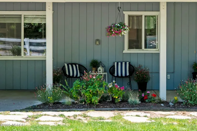 a bedroom with a bed a dresser and next to a window