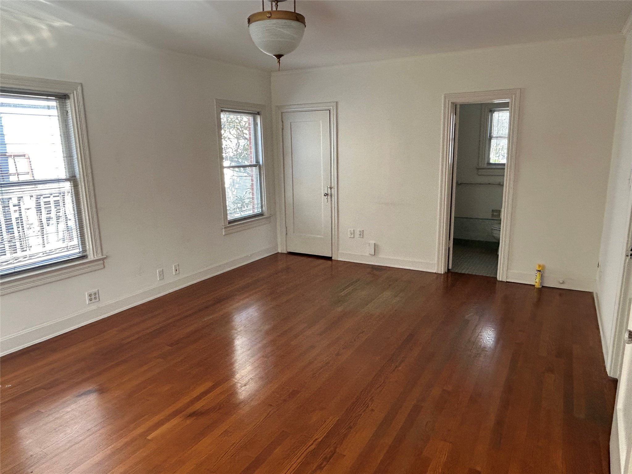 2038 Lexington Street Houston, TX 77098 - Photo 16 of 21 an empty room with wooden floor and windows