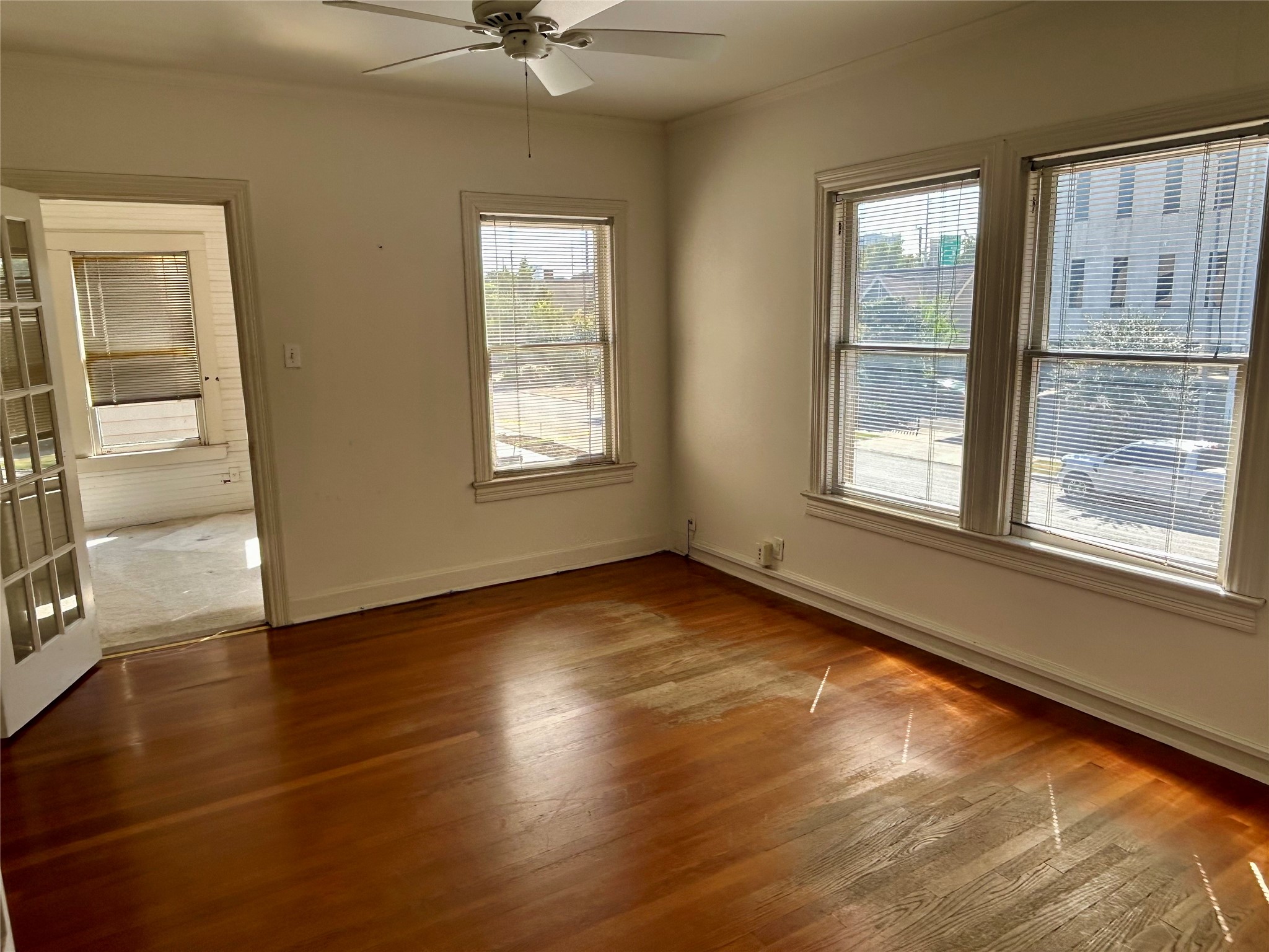 2038 Lexington Street Houston, TX 77098 - Photo 20 of 21 an empty room with wooden floor and windows