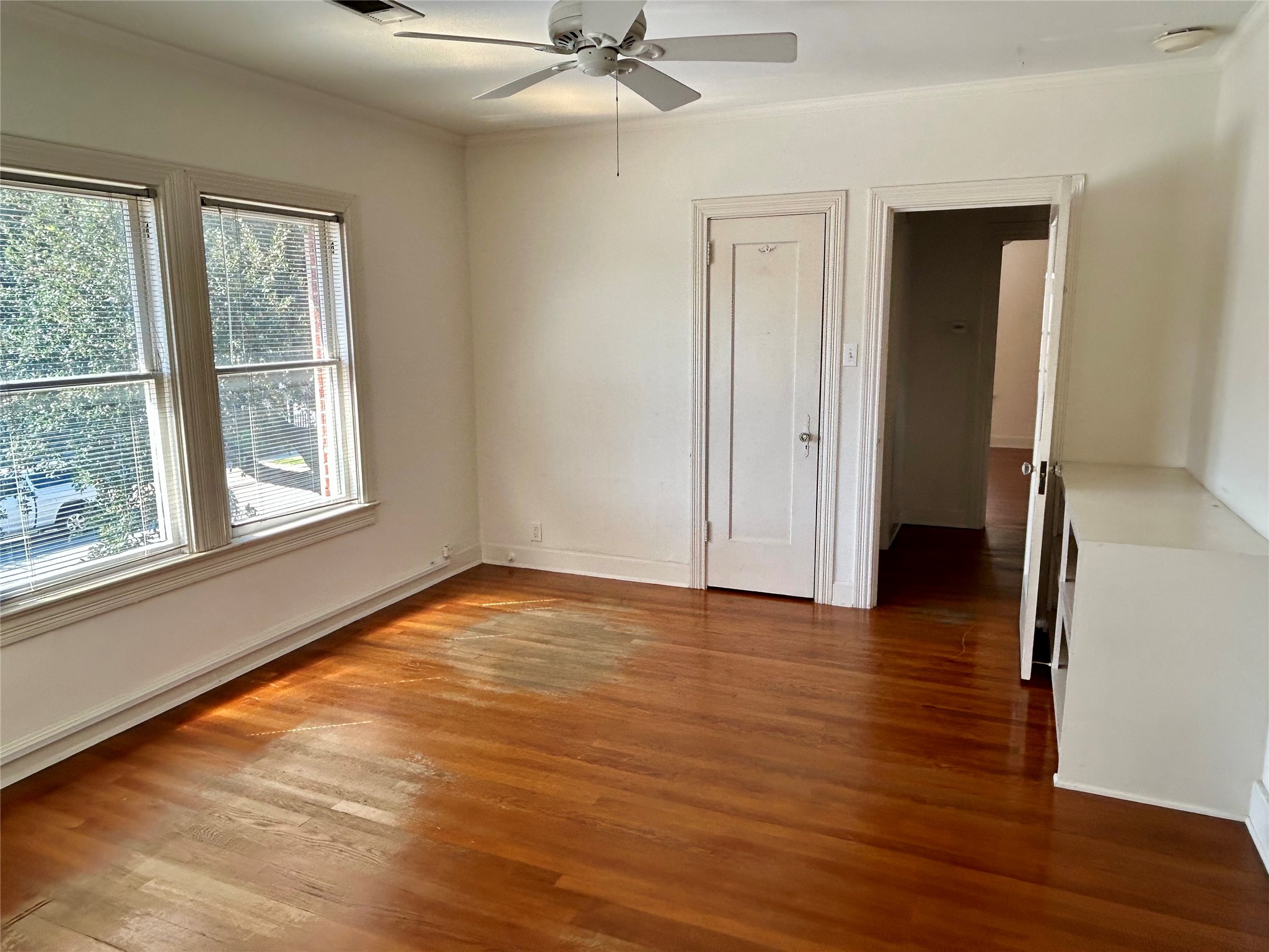 2038 Lexington Street Houston, TX 77098 - Photo 21 of 21 a view of an empty room with wooden floor and a window
