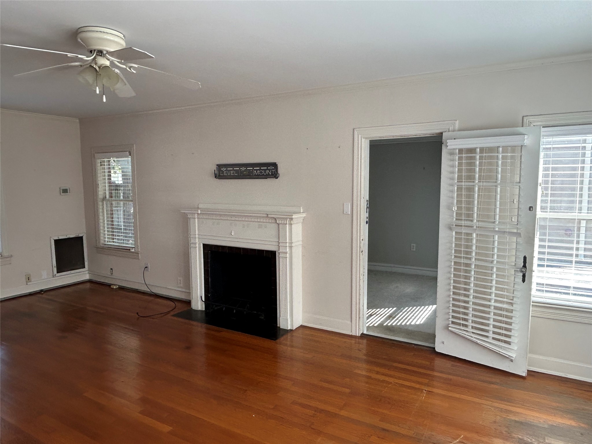 2038 Lexington Street Houston, TX 77098 - Photo 7 of 21 wooden floor fireplace and windows in an empty room
