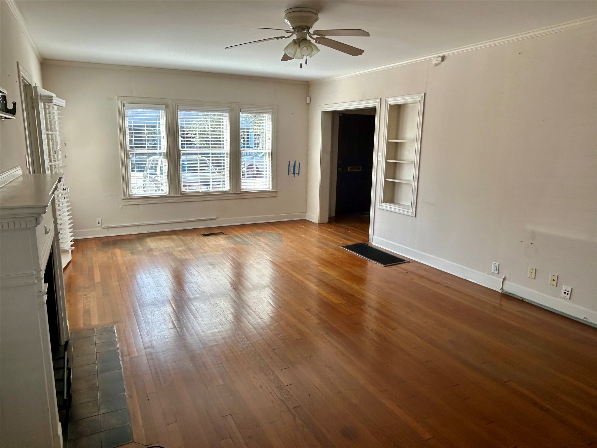 2038 Lexington Street Houston, TX 77098 - Photo 9 of 21 wooden floor in an empty room with a window