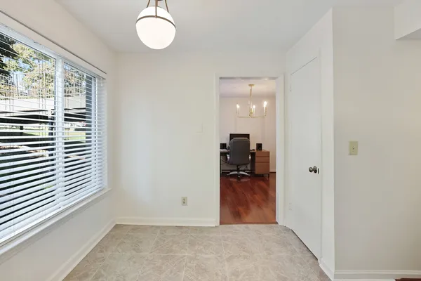 a kitchen with white cabinets and white appliances
