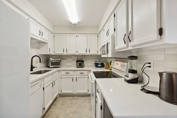 a view of a kitchen with sink and cabinets
