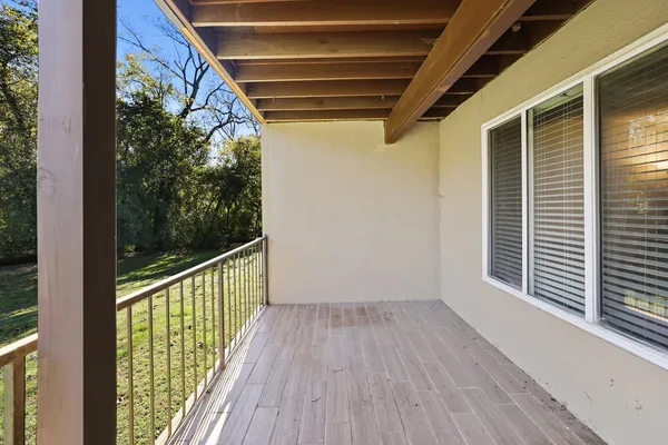 a view of a porch with wooden floor and outdoor space