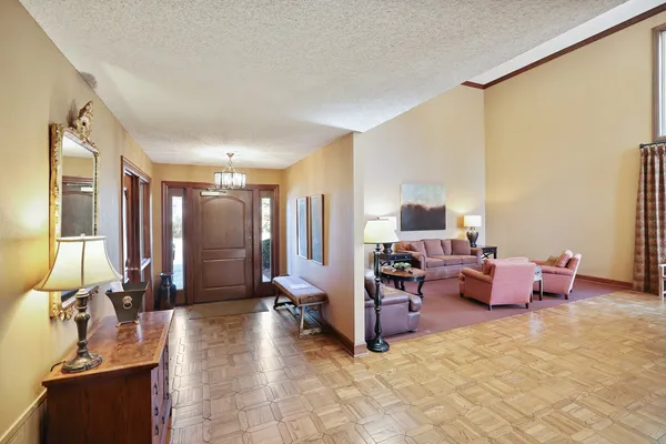 a living room with fireplace furniture and a large window