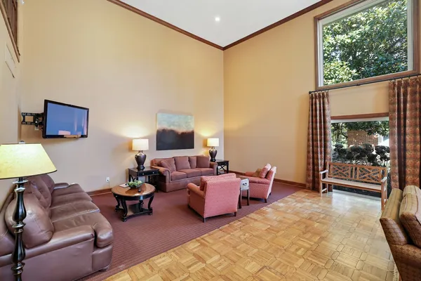 a living room with furniture and a chandelier