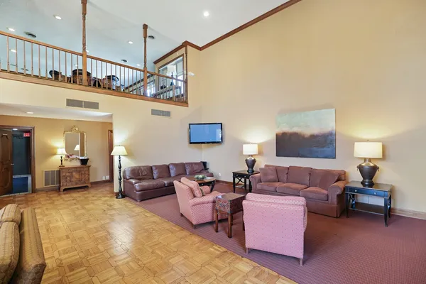a living room with furniture a chandelier and a rug