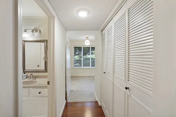 a bathroom with a sink a toilet and mirror