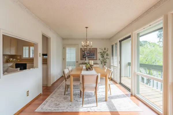 a view of a dining room with furniture window and wooden floor