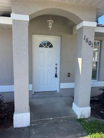 a view of an empty room and a window
