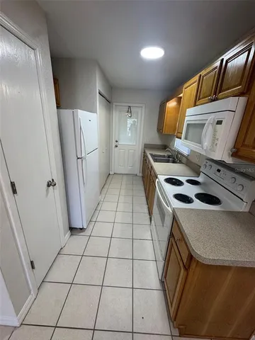 a kitchen with a refrigerator and a stove