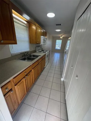en empty room with wooden floor fan and windows