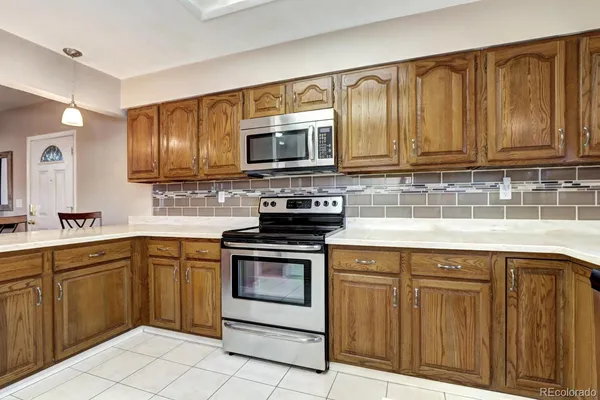 a kitchen with granite countertop wooden cabinets and stainless steel appliances