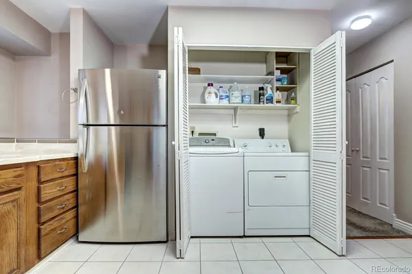 a white refrigerator freezer sitting in a kitchen