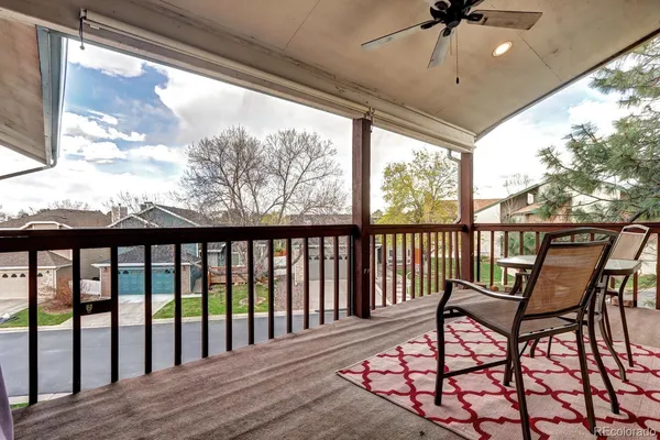 a view of a porch with furniture and a yard